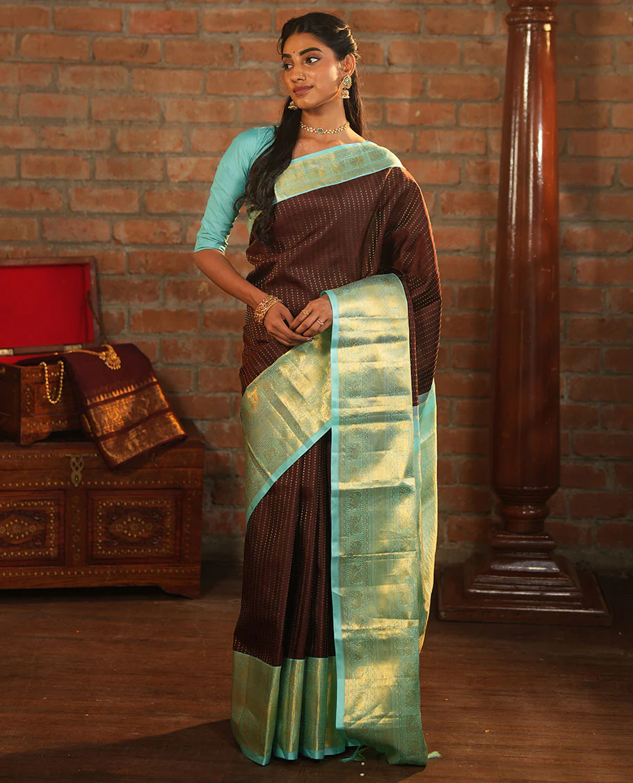 Brown Vasundhara Silk Saree Delicately Woven with Zari Buttas, Highlighted with a Contrast Border of Cross Kamalam, Mayil, Banaras, Yaanai, and Mayil Kann Designs, Pallu Grandly Woven with Jaal Designs, and Paired with a Contrast Blouse - Image 3
