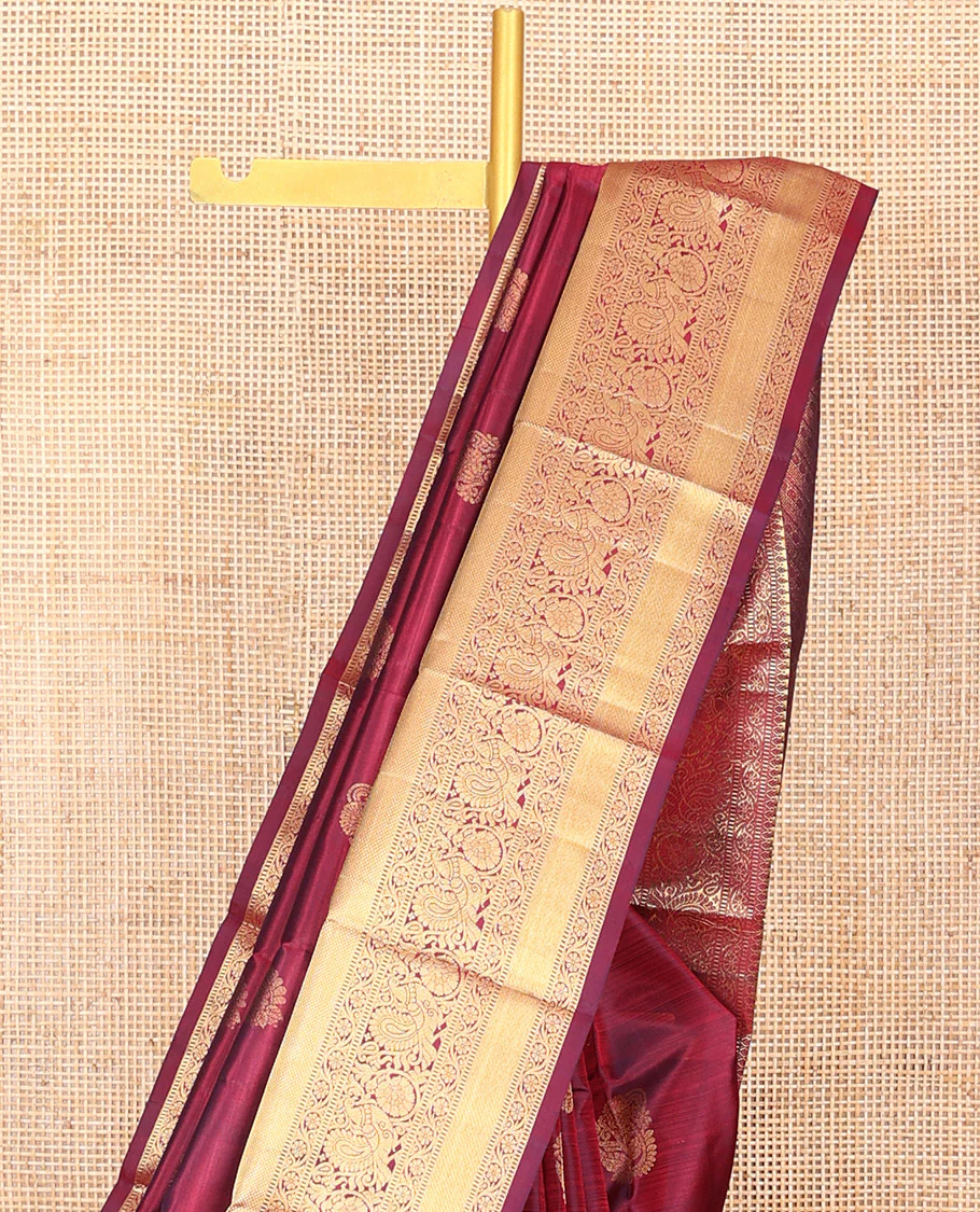 Maroon Vasundhara Silk Saree Ornamented with Zari Buttas All Over Its Body, Highlighted by Zari Border of Rekku, Kodi Visiry, Mayil, and Kuyil Kann Designs, a Grand Pallu of Diagonal Stripes, and Paired with a Matching Blouse - Image 3