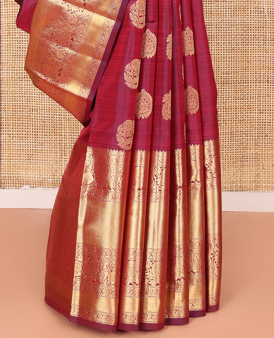Maroon Vasundhara Silk Saree Ornamented with Zari Buttas All Over Its Body, Highlighted by Zari Border of Rekku, Kodi Visiry, Mayil, and Kuyil Kann Designs, a Grand Pallu of Diagonal Stripes, and Paired with a Matching Blouse - Image 4